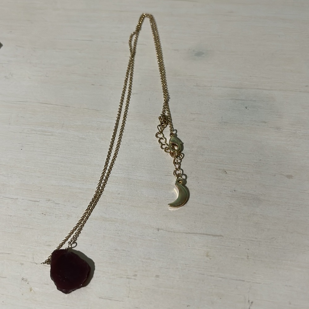 Gold necklace with purple stone